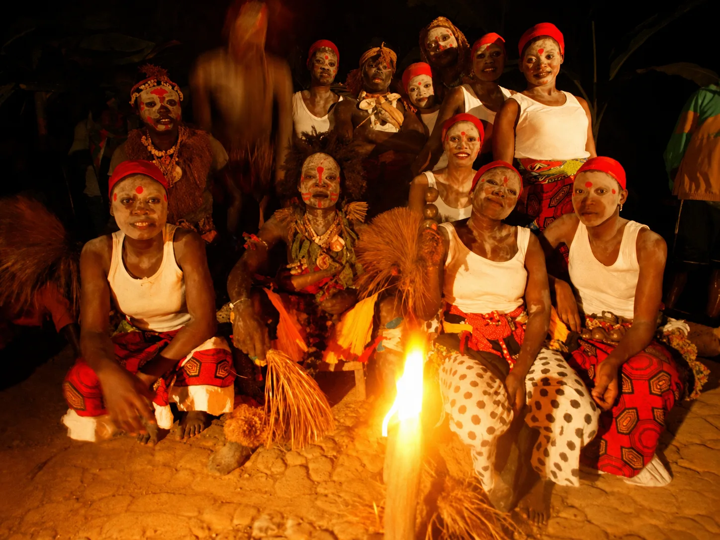 The Ebando community gathered around the fire during a night ceremony