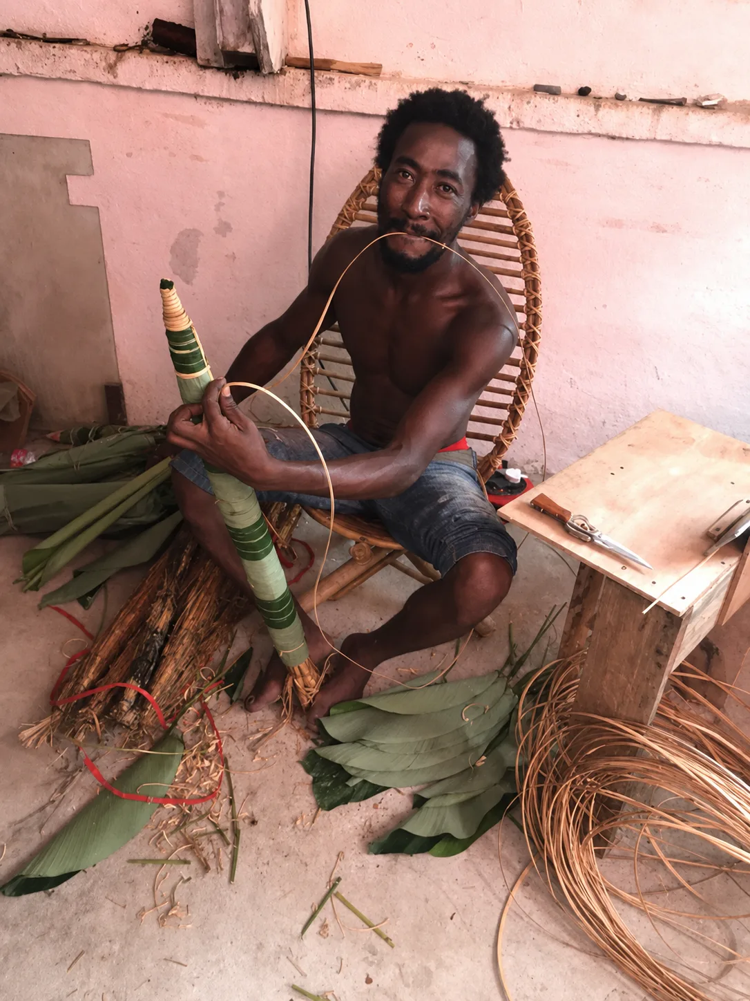 A young man shaping a traditional musical instrument — living sound heritage passed on