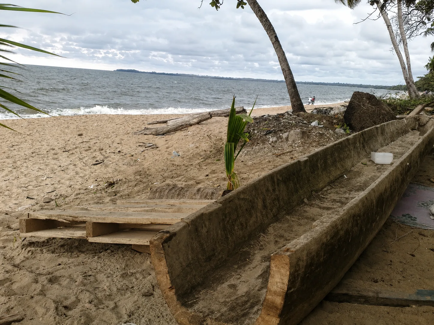 Ebando's pirogue beached on the shore at La Sabliere
